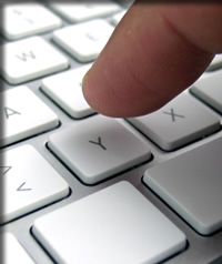 Person typing email on keyboard