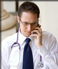 Doctor dictating over a phone and using Transcription Connection’s toll                                        free phone system.